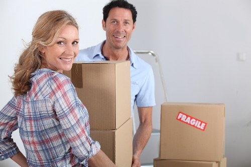 Packed moving boxes and furniture ready for transport in Streatham