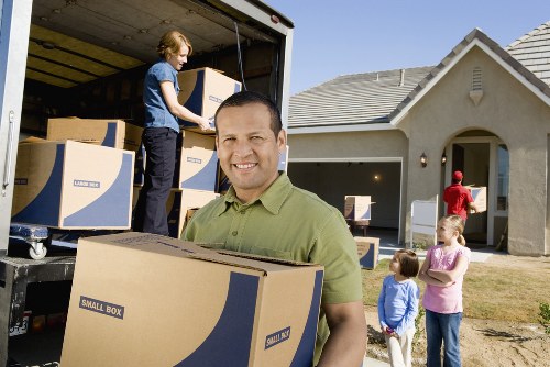 Packed moving boxes and furniture in a local removal van